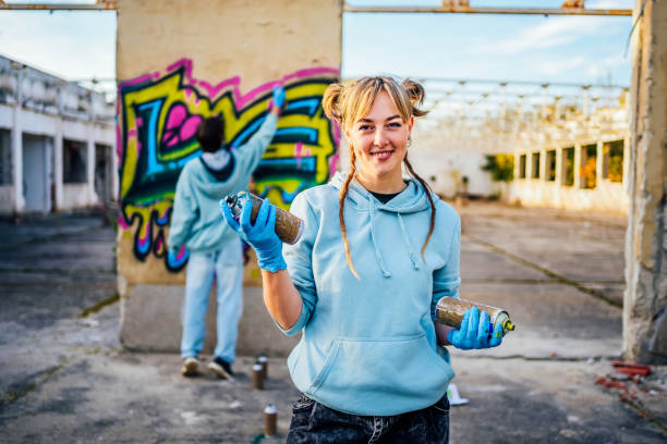 istock Female graffiti artist with spray cans 1824907140