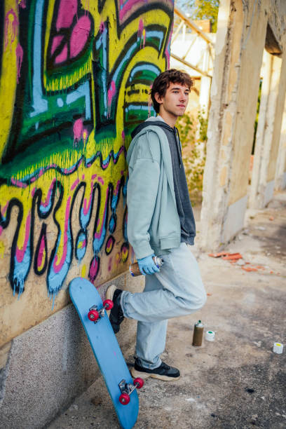istock Male graffiti artist with spray cans 1824909437