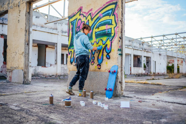 istock Young woman doing graffiti on the wall 1824910067