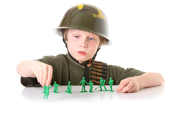 istock boy playing with green army men 182491145