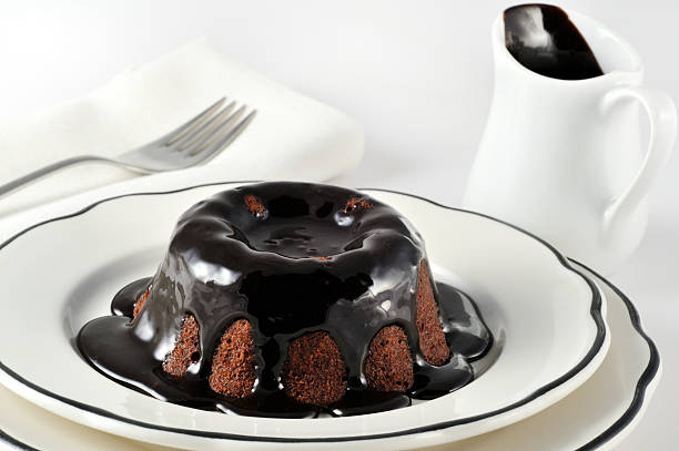 Close-up of chocolate lava cake dessert drizzled in sauce stock photo