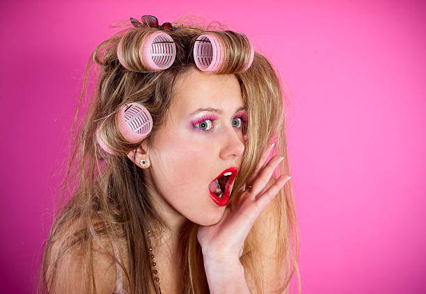 istock Young woman with curlers is surprised 182491202