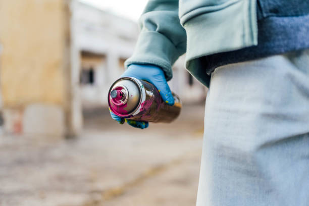 Graffiti artist holding a spray can outdoors