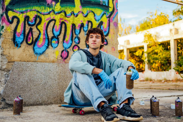 istock Male graffiti artist with spray cans 1824918082