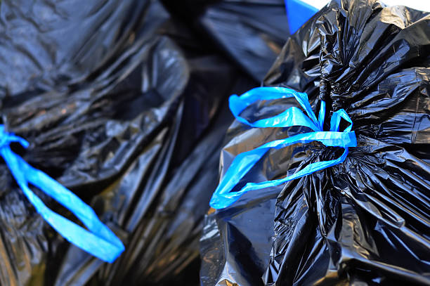 Black garbage bags tied with blue strings Black Garbage bags. garbage bag stock pictures, royalty-free photos & images