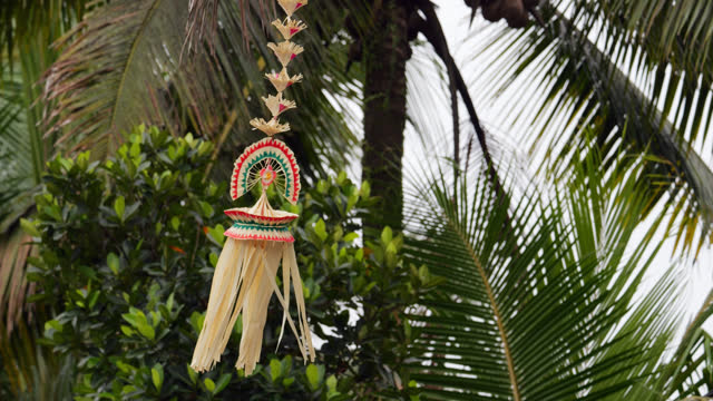 Hand-made decoration hanging at rope on end of penjor pole