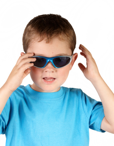 Four year old boy in sunglasses serious pose. Inspector: Shot pre 1st Sept 2009