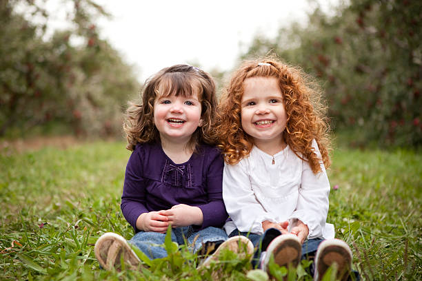 istock Two Happy Sisters Smiling and Laughing Together Outside 182492668