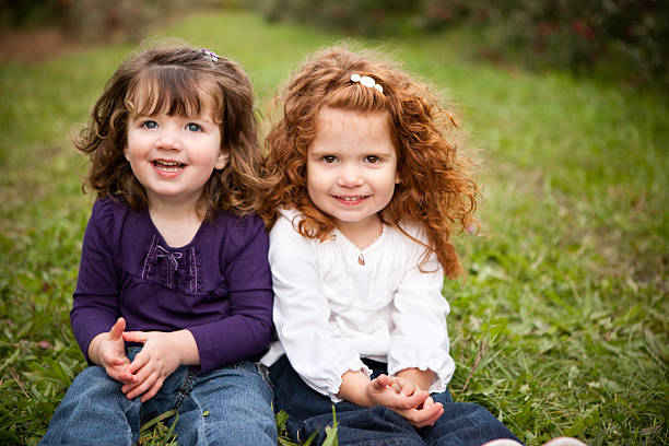 istock Two Happy Sisters Smiling and Laughing Together Outside 182492672