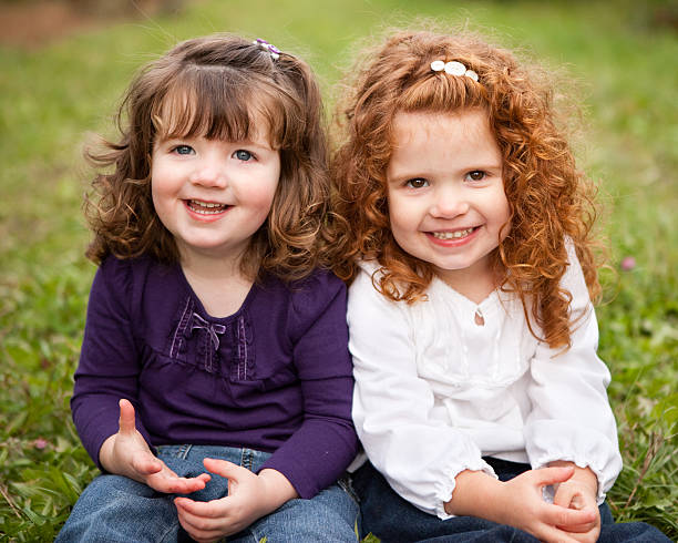 Two Happy Sisters Smiling and Laughing Together Outside