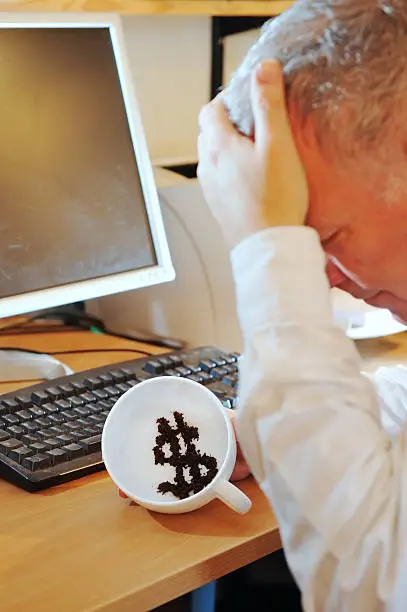 "Businessman/financier showing dollar symbol in tea-leaves, unhappy with the future of the dollar.For different currencies and expressions, please see this LB"