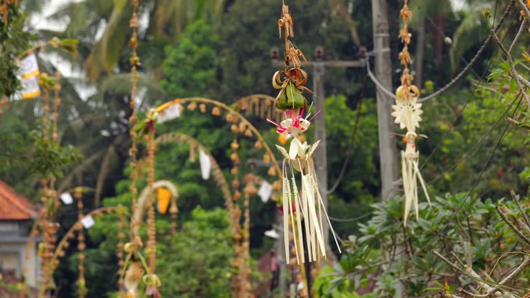 Rather small decorative elements hanging and sway at end of penjor poles