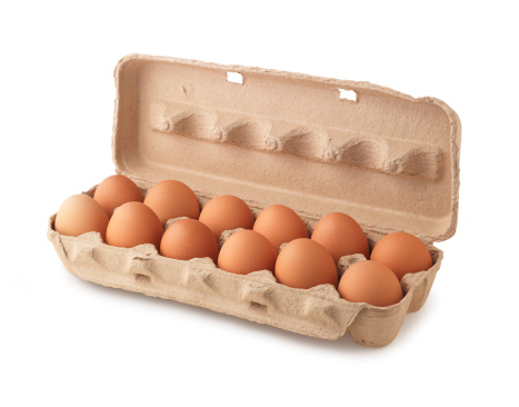 A carton of eggs shot on white with a shadow.