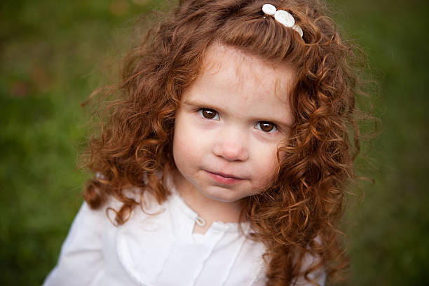 istock Cute Little Red-Haired Girl Looking at Camera 182493628