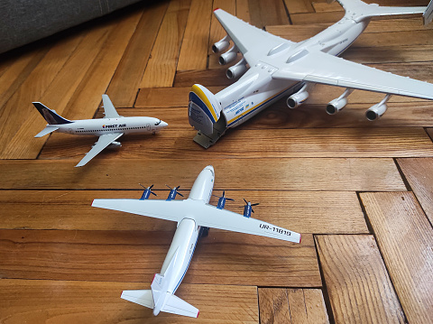 Antonov Airlines An-225, Motor Sich Antonov An-12, and First Air Boeing 737-200 aircraft models on a floor, all in 1:200 scale