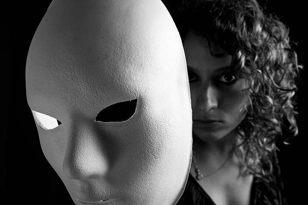 istock Young woman showing true colours behind mask. 182494043
