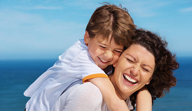 istock Happy boy enjoying being piggybacked by mother 182494268