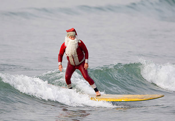 Surfing Santa Claus stock photo