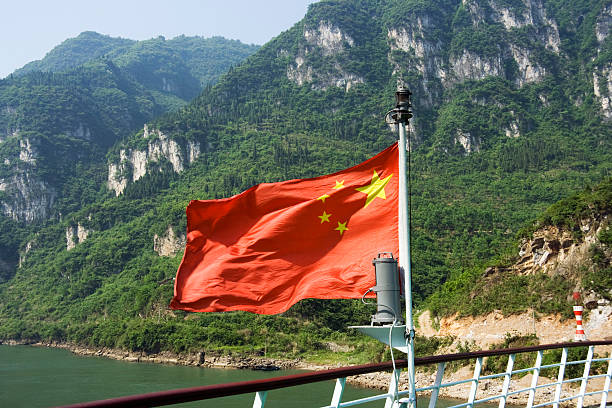 China Flag The Chinese flag flies from the stern of a cruise ship in Xiling Gorge on the Yangtze River.Please see my China Lightbox: three gorges photos stock pictures, royalty-free photos & images