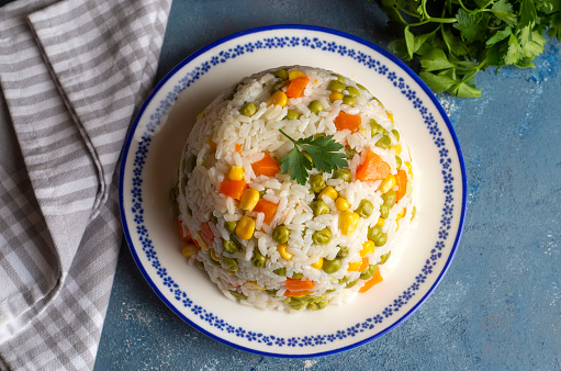 Delicious vegetable rice pilaf with green peas, carrots and sweet corn (Turkish name; sebzeli pilav)