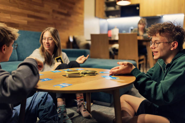 Teenagers playing card game at home