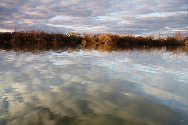 Blue sky and clouds reflecting in the water