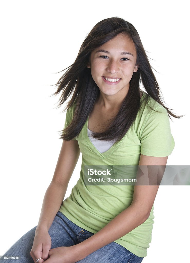 Beautiful Smiling Teenage Girl on White Background A beautiful fourteen year old girl sitting down on a white background. 14-15 Years Stock Photo