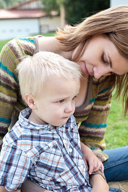 istock sad baby boy on his mom's lap 182496959