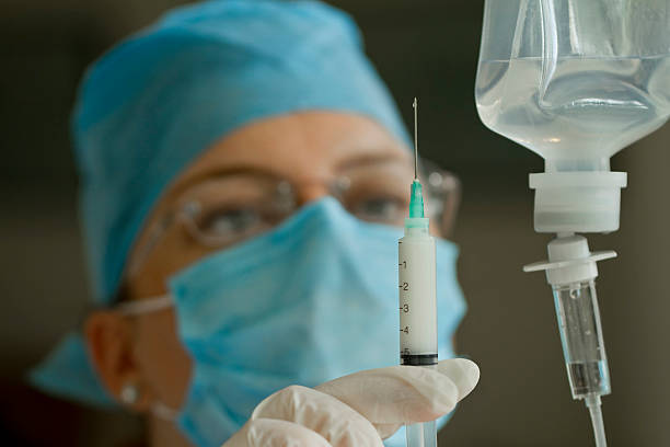 Doctor Preparing Anesthetic Syringe stock photo