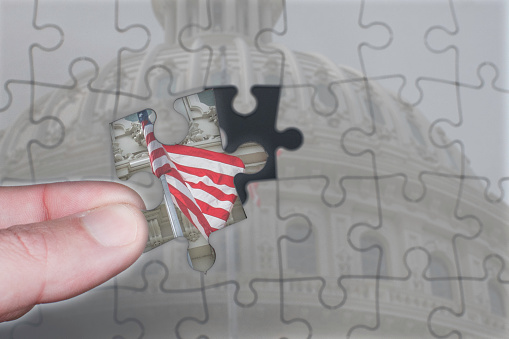 Placing the last piece of a puzzle of the United States Capitol