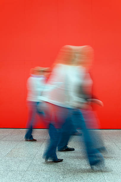 istock Motion Blurred Women Walking Against a Red Wall 182497426