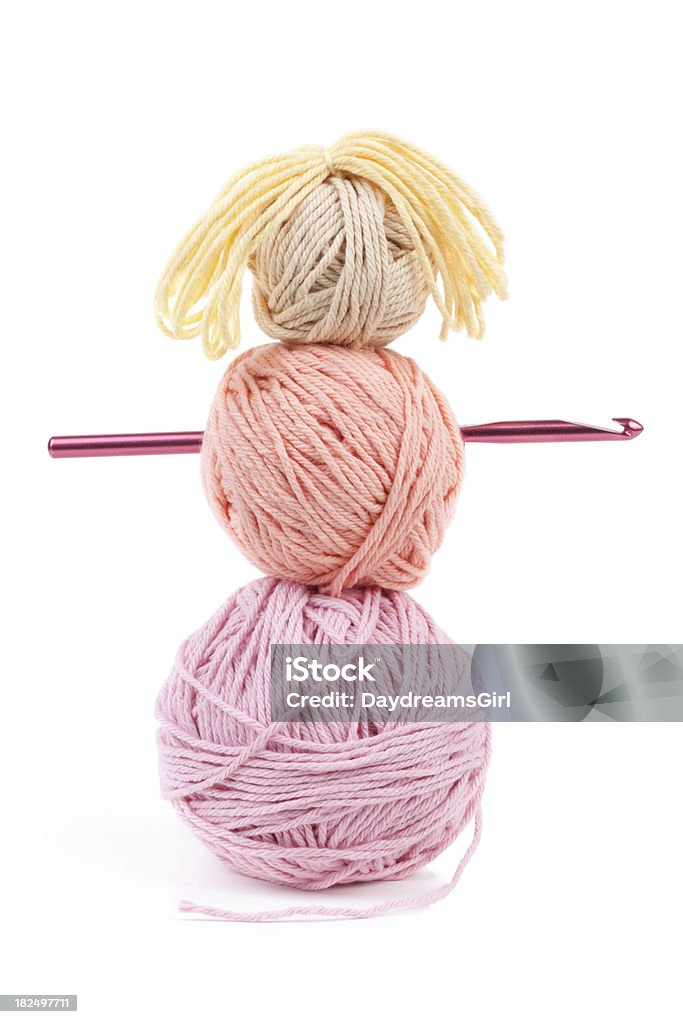 Craft Yarn Doll "Three balls of yarn stacked snowman style, with a crochet hook for the arms. Isolated on white background." Crochet Hook Stock Photo
