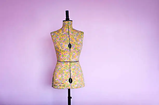 Photo of Dressmakers Dummy or Mannequin Against a Pink Background