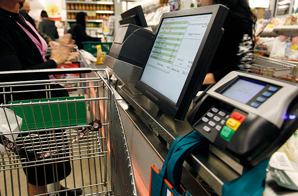 A person at the cash register of a supermarket stock photo