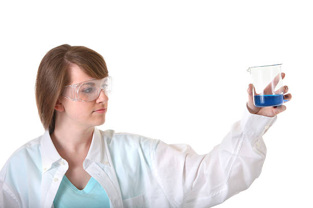 istock young woman scientist looking at beaker 182498074