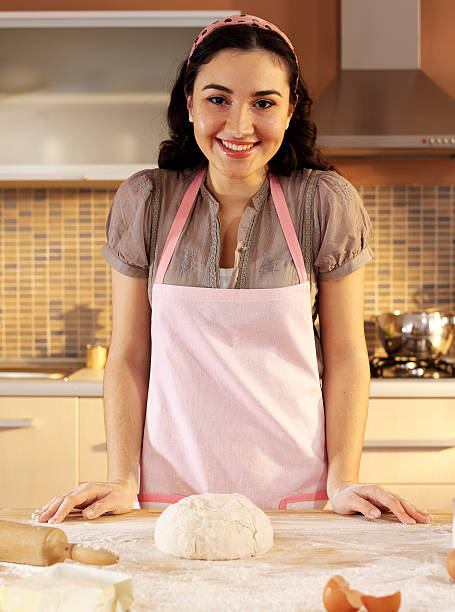 istock Young woman kneading dough 182498486