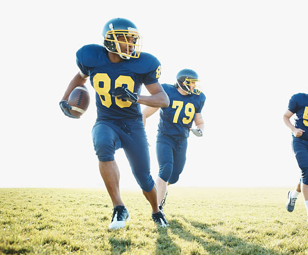 Young footballers in blue uniform playing a game on the field