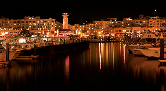 Long exposure of Cabo San Lucas marina at night.  Some slight motion blur on boats.