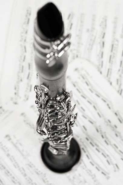 Clarinet on Sheet Music Wooden clarinet with shallow depth of field on sheet music.   klezmer stock pictures, royalty-free photos & images