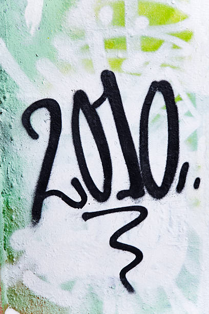 istock Year 2010 in black spray paint on graffiti wall. 182499373