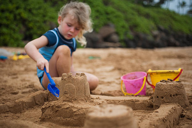 istock Girl Building Sandcastle 182499383