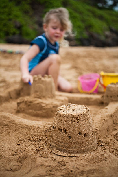 istock Girl Building Sandcastle 182499392