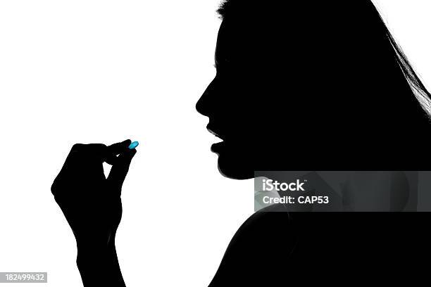 Woman Taking A Pill Stock Photo - Download Image Now - Adult, Adults Only, Back Lit