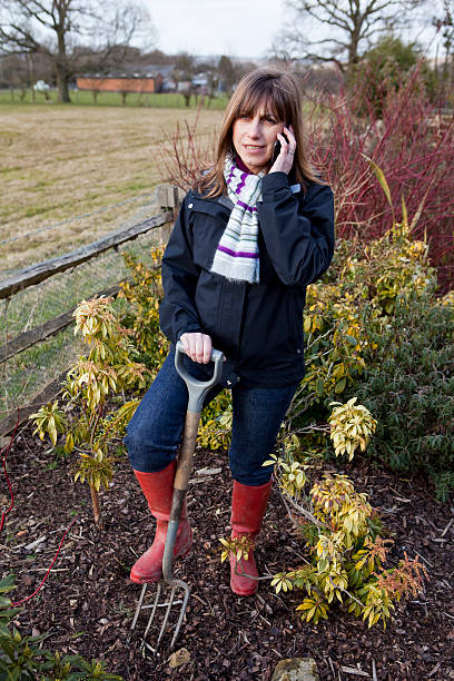istock Woman Gardener on Mobile Phone 182500148