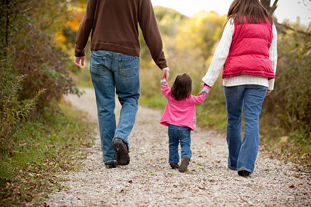 istock Happy Family Walking on Trail Through Autumn Woods 182500182