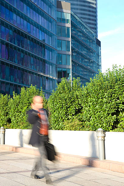 istock Businessman Walking, Using Mobile Phone, Carrying Suitcase, Blurred Motion 182500474