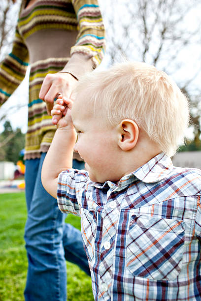 istock walking with mom at the park 182501588