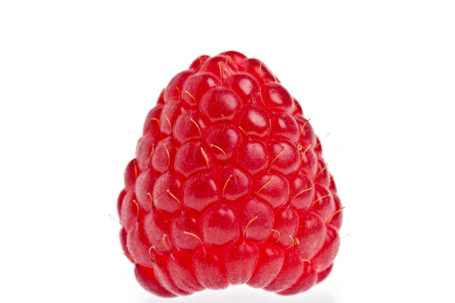 A macro of a raspberry on a white background.