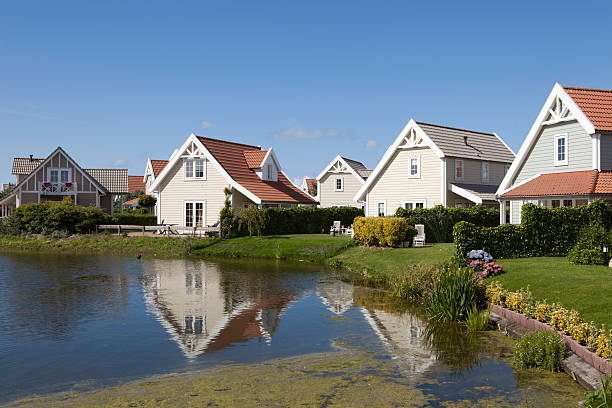 reflection of Scandinavian style holiday houses in the water stock photo