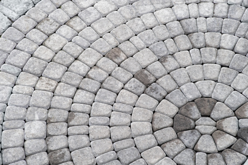 concentric pattern / of patio paving stones / pleasing to the eye